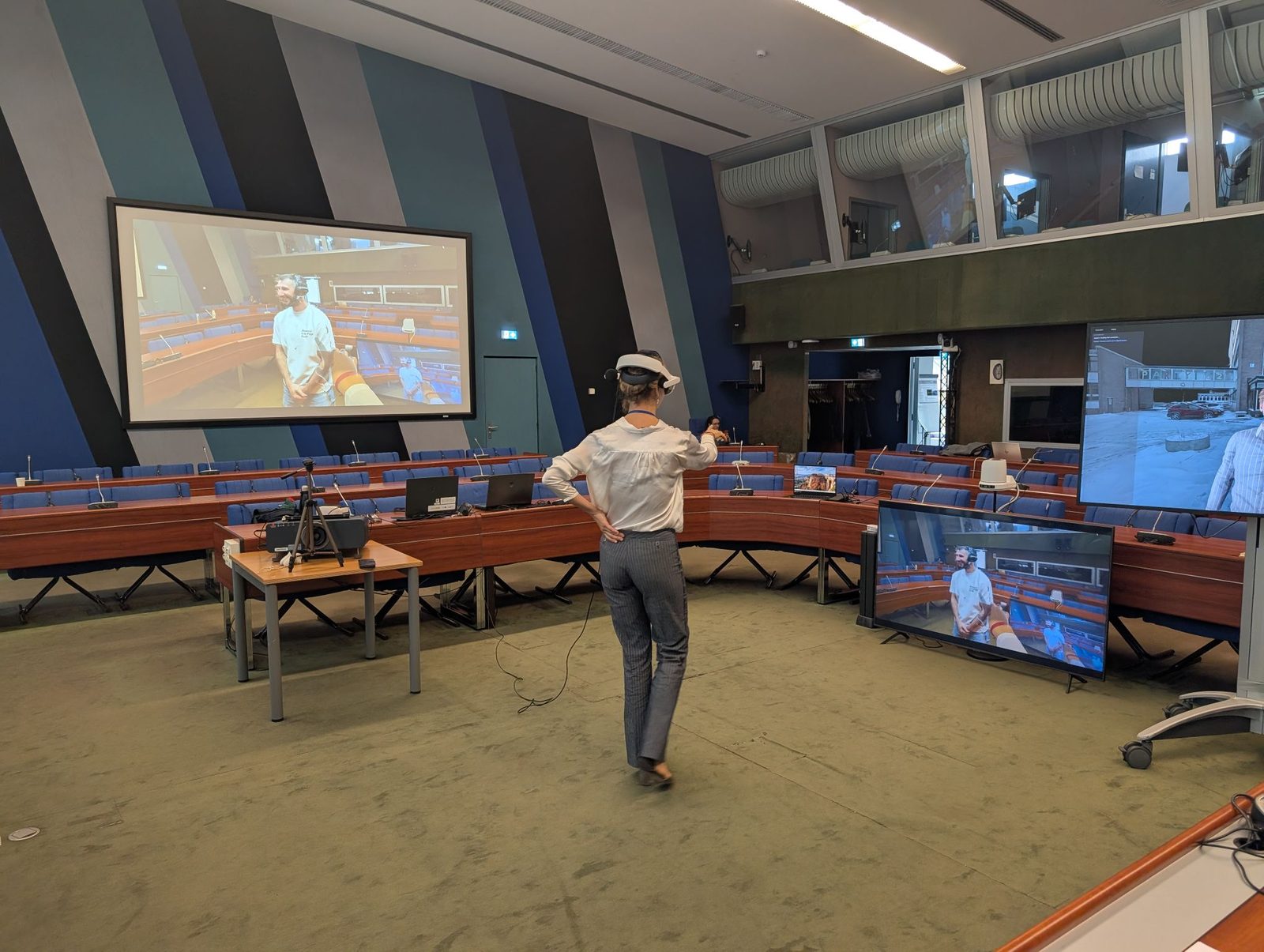 A participant wearing a mixed reality headset during the live holoportation demo in a Council of Europe conference room