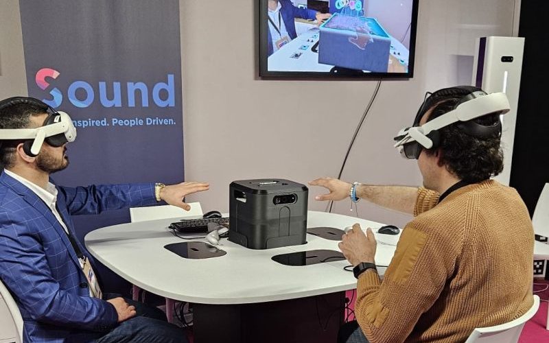 Two attendees wearing mixed reality headsets during the live holoportation demo at the PRESENCE-xr stand at Laval Virtual