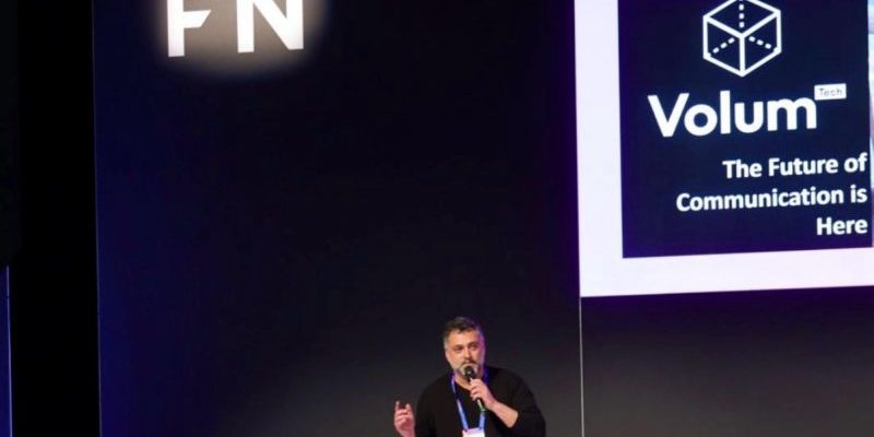 Volum presenting on the 4YFN stage at MWC 2026, in front of a screen reading “The Future of Communication is Here”